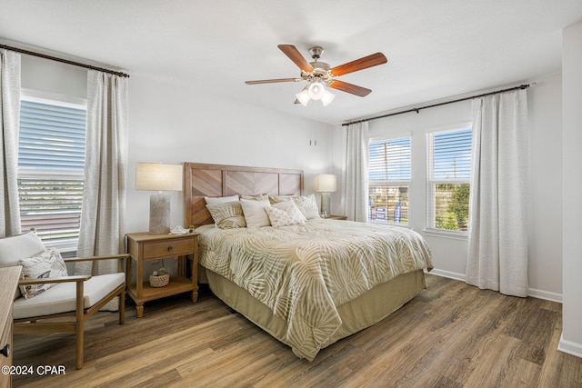 bedroom with ceiling fan and hardwood / wood-style floors