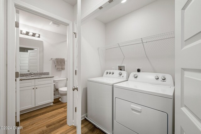 full bathroom featuring hardwood / wood-style flooring, vanity, toilet, and tub / shower combination