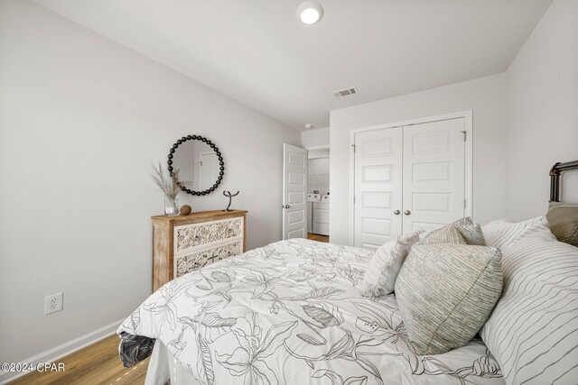 bedroom featuring hardwood / wood-style flooring and a closet