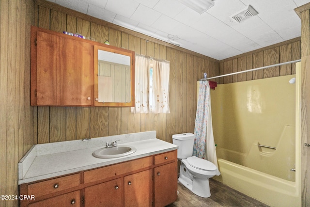 full bathroom featuring shower / bath combo with shower curtain, vanity, hardwood / wood-style floors, and toilet