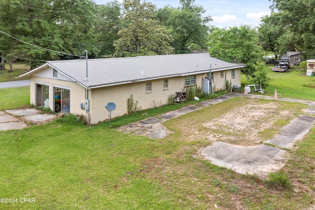 rear view of property with a yard