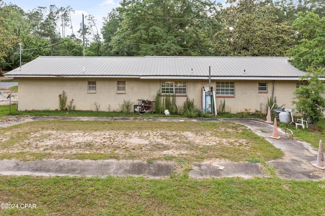 back of property featuring a yard