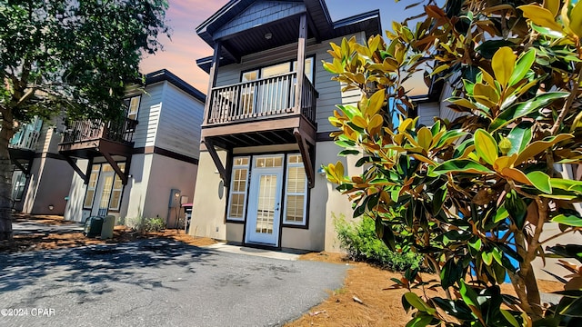 exterior entry at dusk with a balcony