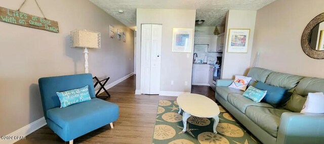 living area featuring baseboards and wood finished floors