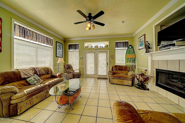 living room with a tile fireplace, a textured ceiling, and light tile patterned flooring