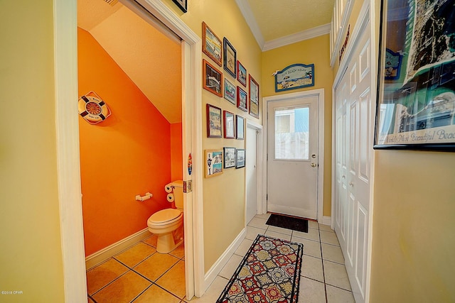 doorway featuring lofted ceiling, light tile patterned floors, and crown molding