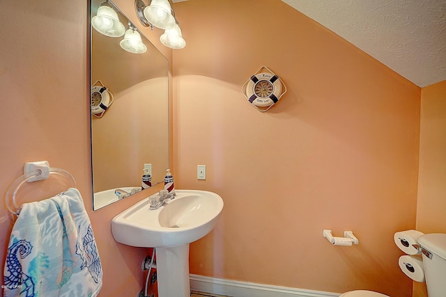 bathroom with a textured ceiling and toilet