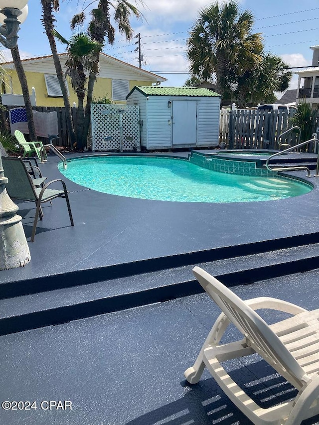 view of pool featuring an outbuilding