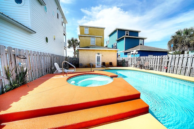 view of pool featuring an in ground hot tub