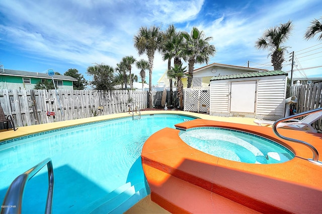 view of swimming pool with an in ground hot tub and a shed