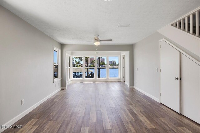 bathroom featuring toilet, vanity, a textured ceiling, and hardwood / wood-style floors