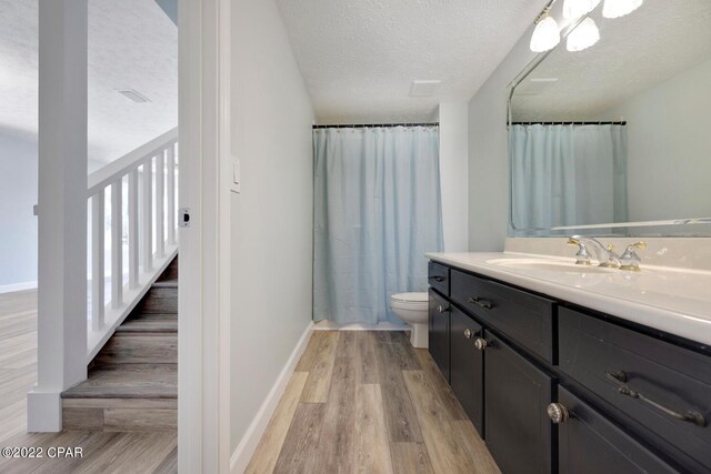 office featuring a textured ceiling, ceiling fan, and light hardwood / wood-style floors