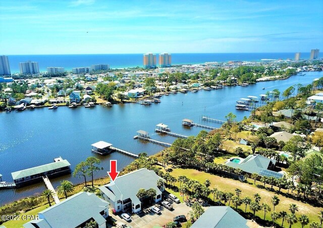 view of dock featuring a lawn and a water view