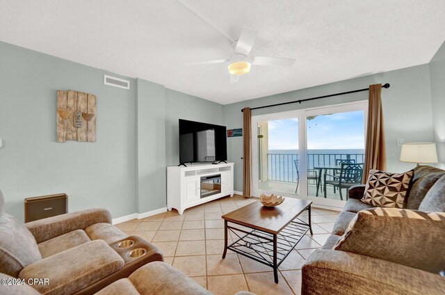 tiled living room featuring ceiling fan