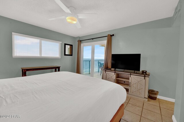 bedroom with access to outside, light tile patterned floors, and ceiling fan