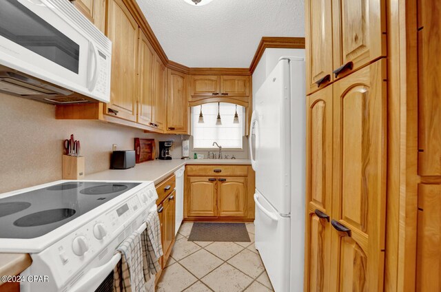 kitchen with crown molding, white appliances, light tile patterned floors, a textured ceiling, and sink