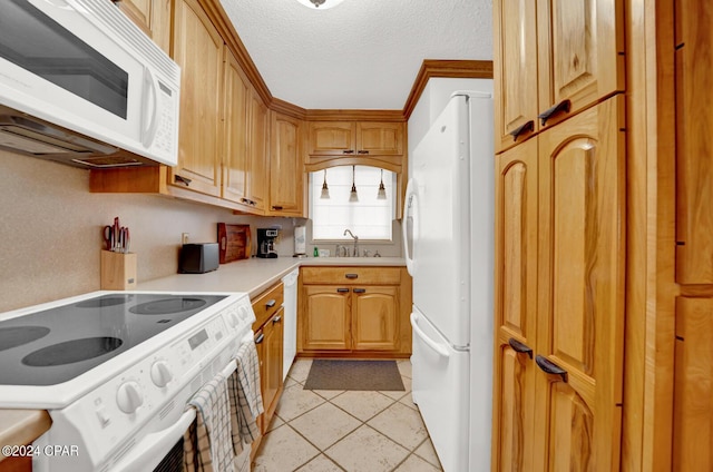 kitchen with sink, light tile patterned floors, white appliances, crown molding, and a textured ceiling