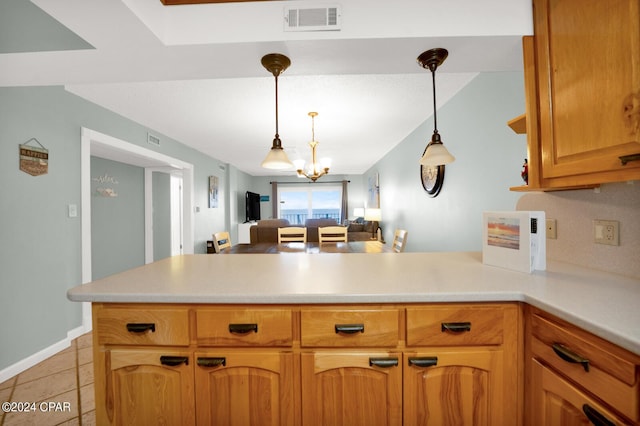 kitchen featuring light tile patterned flooring, kitchen peninsula, a chandelier, and pendant lighting