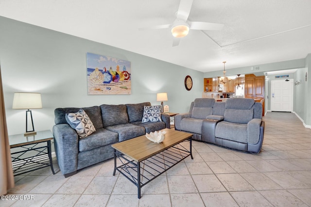 living room featuring ceiling fan with notable chandelier