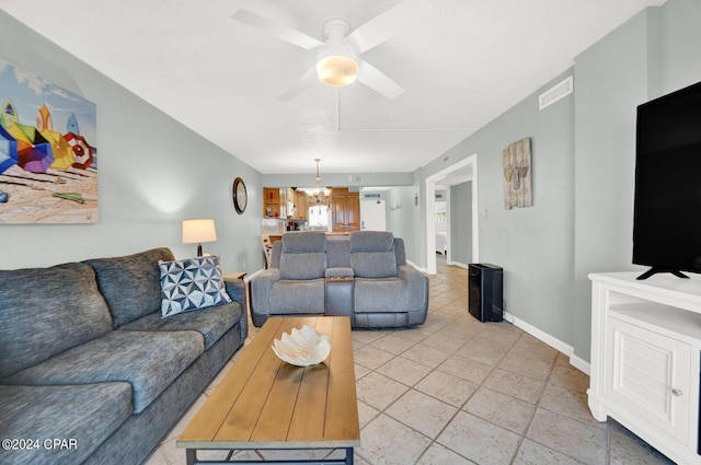 living room featuring ceiling fan with notable chandelier