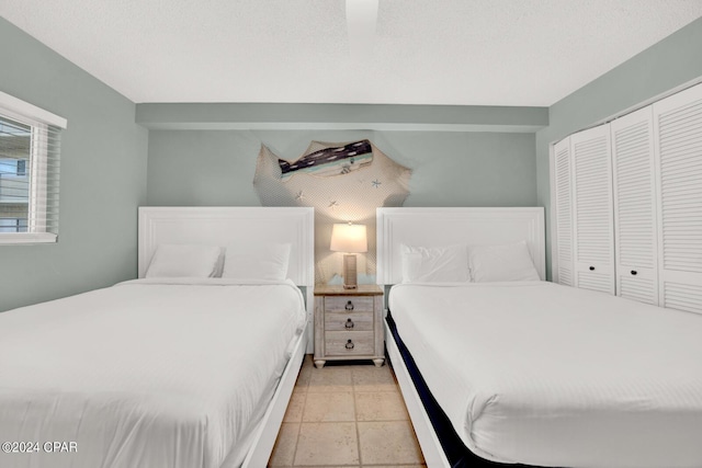 tiled bedroom featuring a closet