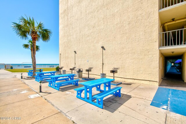 view of pool with a water view and a patio