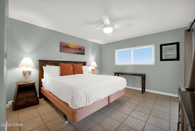 tiled bedroom featuring ceiling fan