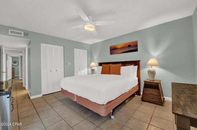 bedroom featuring multiple closets and ceiling fan