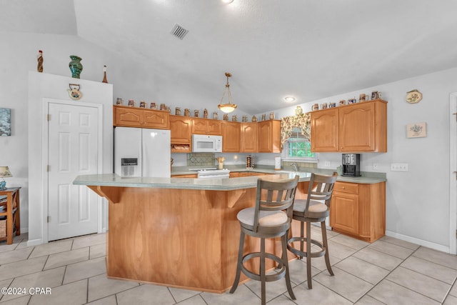 kitchen with lofted ceiling, light tile patterned floors, white appliances, a center island, and decorative light fixtures