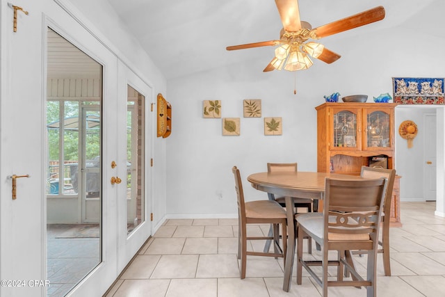 dining space featuring vaulted ceiling, ceiling fan, light tile patterned floors, and french doors