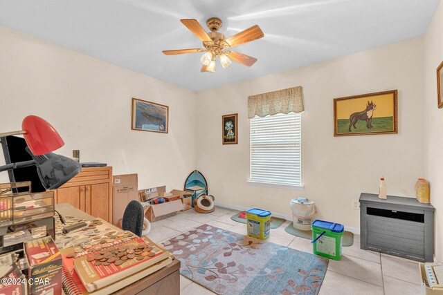 tiled office featuring ceiling fan