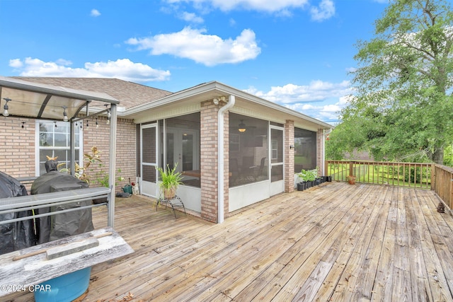 wooden deck featuring a sunroom