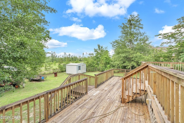 wooden terrace with a yard and a storage unit