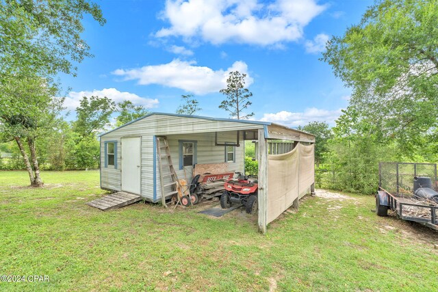 view of outbuilding with a yard