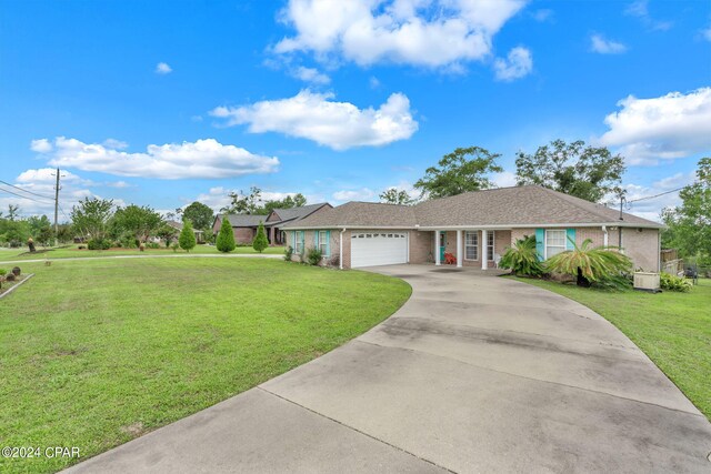 single story home featuring a garage and a front lawn