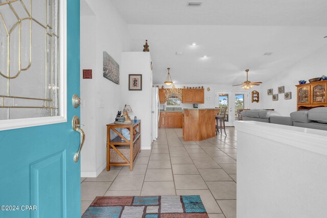 foyer entrance featuring ceiling fan, light tile patterned flooring, and french doors