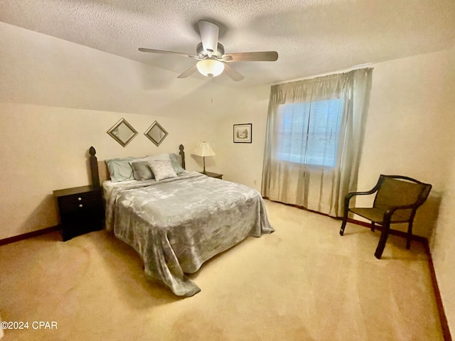 bedroom with a textured ceiling, lofted ceiling, light carpet, and ceiling fan