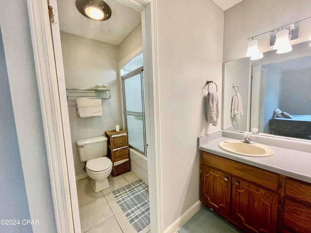 full bathroom with enclosed tub / shower combo, vanity, toilet, and tile patterned floors