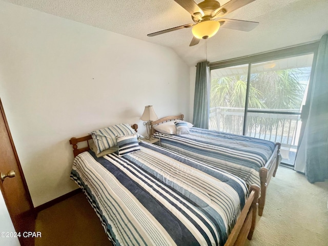 bedroom featuring vaulted ceiling, ceiling fan, carpet flooring, and a textured ceiling