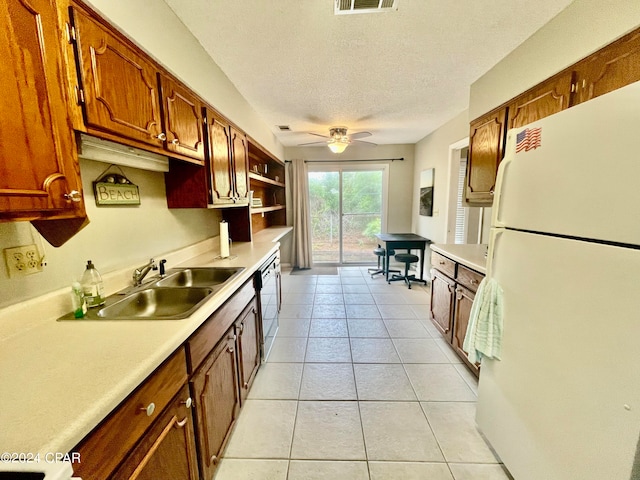 kitchen with ceiling fan, light tile patterned floors, sink, a textured ceiling, and white fridge