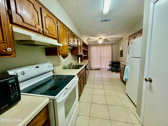 kitchen featuring white appliances, ceiling fan, light tile patterned floors, and sink