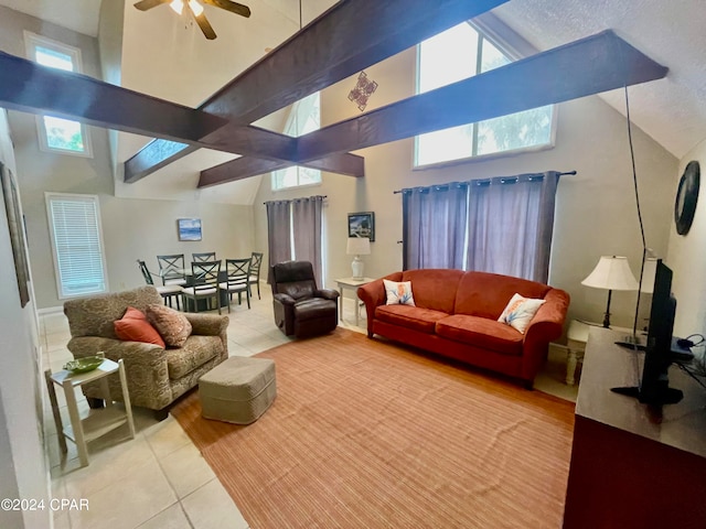 tiled living room featuring high vaulted ceiling, a wealth of natural light, ceiling fan, and beamed ceiling