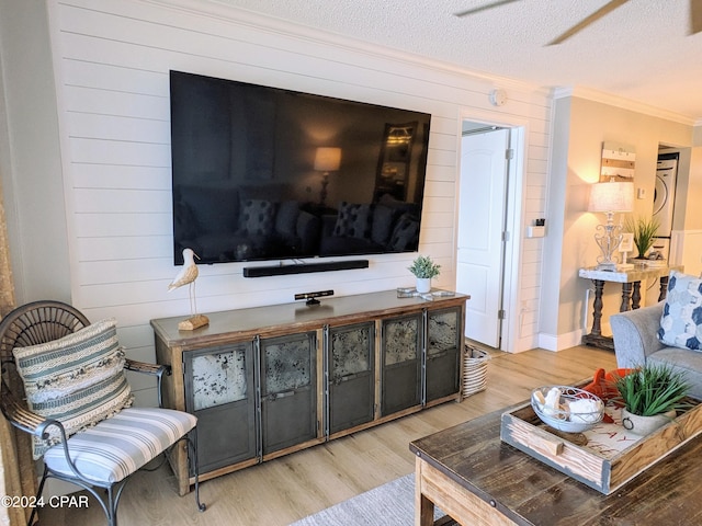 living room with a textured ceiling and light wood-type flooring