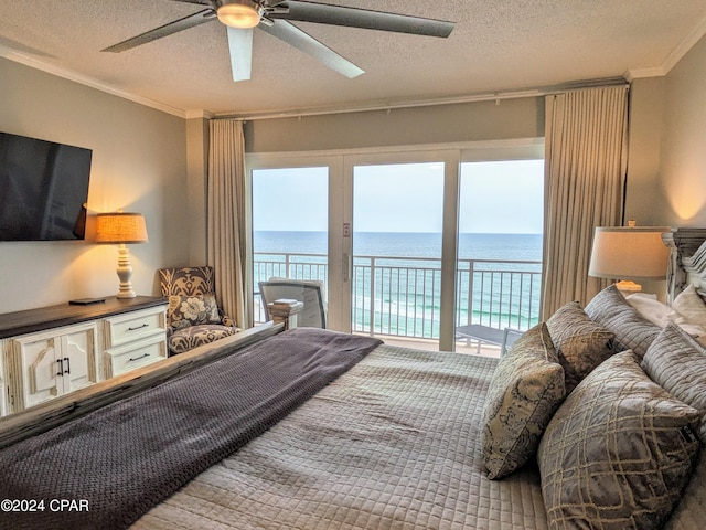 bedroom featuring a water view, ceiling fan, a textured ceiling, and access to outside