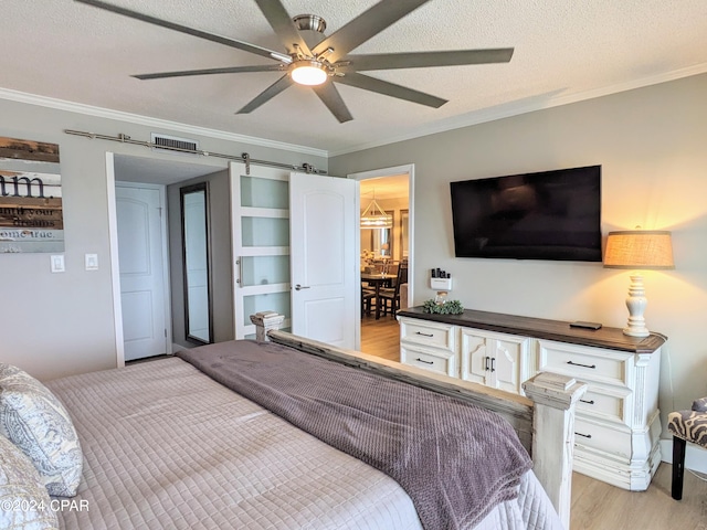 bedroom featuring ceiling fan, ornamental molding, and light wood-type flooring