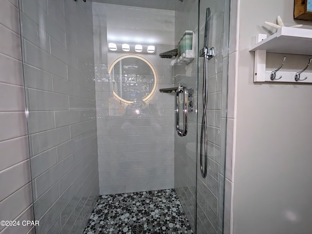 bathroom with a shower with door