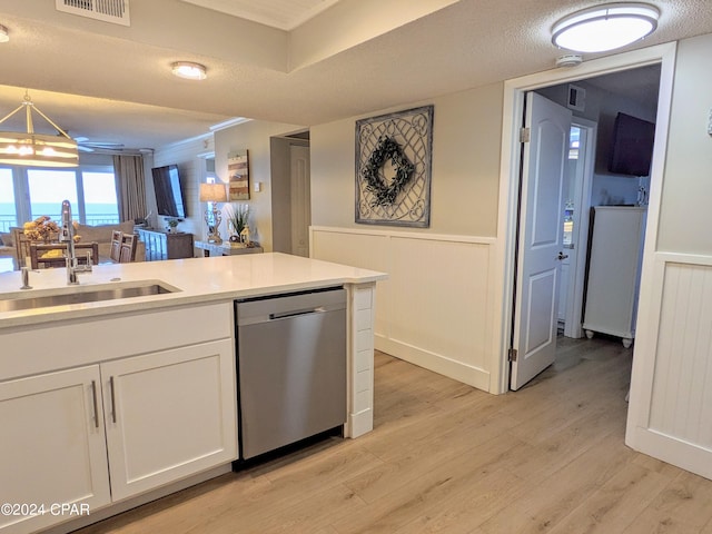 kitchen with sink, light hardwood / wood-style floors, white cabinets, and stainless steel dishwasher