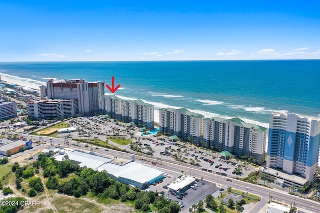 drone / aerial view featuring a beach view and a water view