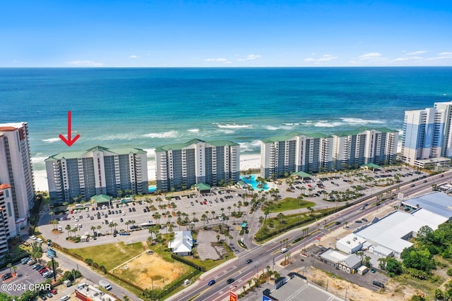 birds eye view of property featuring a water view and a beach view