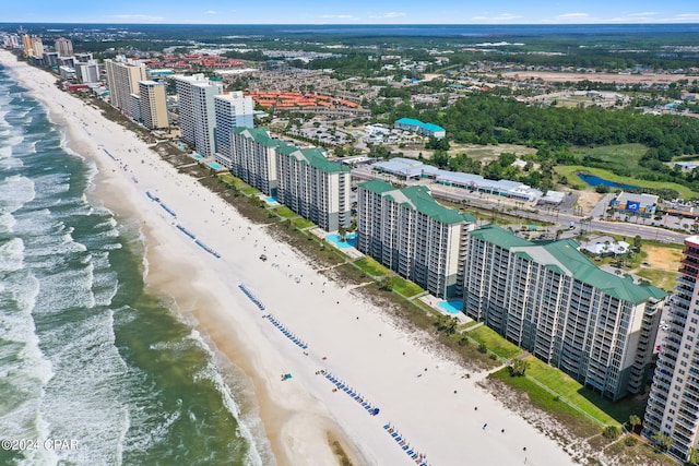 aerial view with a water view and a beach view